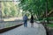 Two people in love are standing at the idle fountain in the park.