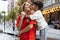 Two people, mother and little cute son strolling at street, trade square in summer time, outdoors. Family time