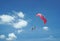 two people parachute high in the blue sky