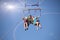 two people parasailing on beach in summer. Happy couple kissing under parachute in air above surface of the sea