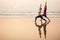 Two people practicing yoga in the sunset light on goa india beach. female and male acro yogi tantra flying copyspce