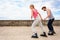 Two people race together riding rollerblades.