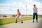 Two people race together riding rollerblades.