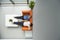 Two People Reclining On Orange Sofa At Office