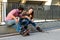 Two people on rollerblades sitting.