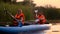 Two people in rowing oars sitting in a kayak on the lake in the sunset. Slow motion