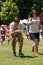 Two People Run In Egg and Spoon Race At Festival