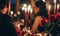 two people sitting in formal attire at dinner with candles and roses