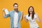 Two people in sterile face masks throw out napkin isolated on yellow background studio. Epidemic pandemic rapidly