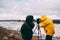 Two people taking photos of the popular and famous place of interest Geysir in Iceland