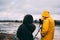 Two people taking photos of the popular and famous place of interest Geysir in Iceland