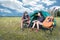 Two people talking near camping tent in meadow field. Male and female traveler looking at attraction view point. Couples adventure