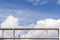 Two people walk on a suspended pedestrian bridge with a dramatic sky in the background in the government district of Berlin