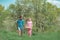 Two people walking in agricultural field. Earth day. A pair of farms working in the garden. Couple Farmers. Wife and