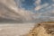 Two people walking on a Bertra beach, county Mayo, Ireland. Beautiful cloudy sky. Couple outdoor by the ocean