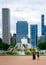 Two people walking in front of Buckingham Foundation with the Chicago skyline