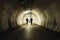 Two people walking in the tunnel