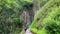 Two people walking up a pass with steep cliffs