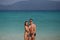 Two perfect bodies person posing on sea background. Male and female