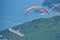 Two person fly on paragliding against city of Budva