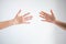 Two person playing rock paper scissors with both posturing paper symbol on white background