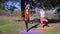 Two persons doing couple yoga namaste pose on the beach at sunset