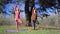 Two persons doing couple yoga namaste pose on the beach at sunset