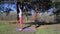 Two persons doing couple yoga namaste pose on the beach at sunset