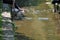 Two persons having their feet in a river to cool down