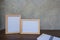 Two photo Frame on a wooden table and book on Gray wall background .