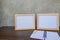 Two photo Frame on a wooden table and book on Gray wall background .