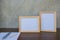 Two photo Frame on a wooden table and book on Gray wall background .