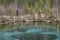 Two photographers taking pictures near a geyser lake