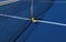 Two pickleball paddles with a whiffle ball at the net