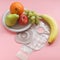 Two piece ostomy appliance including flange, pouch with a side plate of fruit