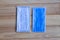 Two pieces of blue Sanitary mask on wooden background, medical mask, medical protective mask, blue surgical mask, Face mask for