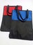 Two pieces of cordura bags. The color combination is black with red and black with blue isolated by a white background