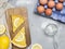 Two pieces of lemon tart with slice of lemons closeup on stone background, eggs and flour, top view, copy space