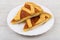 Two pieces of shortbread pie in white plate on table