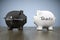 two piggy banks with the words black money and taxes