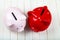 Two pigs piggy banks on a white wooden background