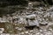 Two piles of stacked rocks, balancing in a riverbed, rock balancing