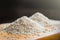 Two piles of white rice on wooden table background, metaphor ing