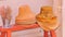 Two piles of woman, straw, sun hats and pail of dried flowers