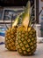 Two pinacolada coctails in fresh pineapple fruit on the beachbar table.