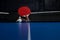 Two ping pong rackets. Table tennis rackets and a ball on a blue tennis table