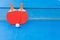 Two pingpong rackets and ball and net on a blue pingpong table