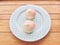 Two pink birthday peach buns on a blue plate. Chinese traditional birthday food.