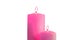 Two pink burning candles on white background