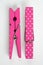 Two Pink Clothes Pins with Fun Patterns One Flipped Top View